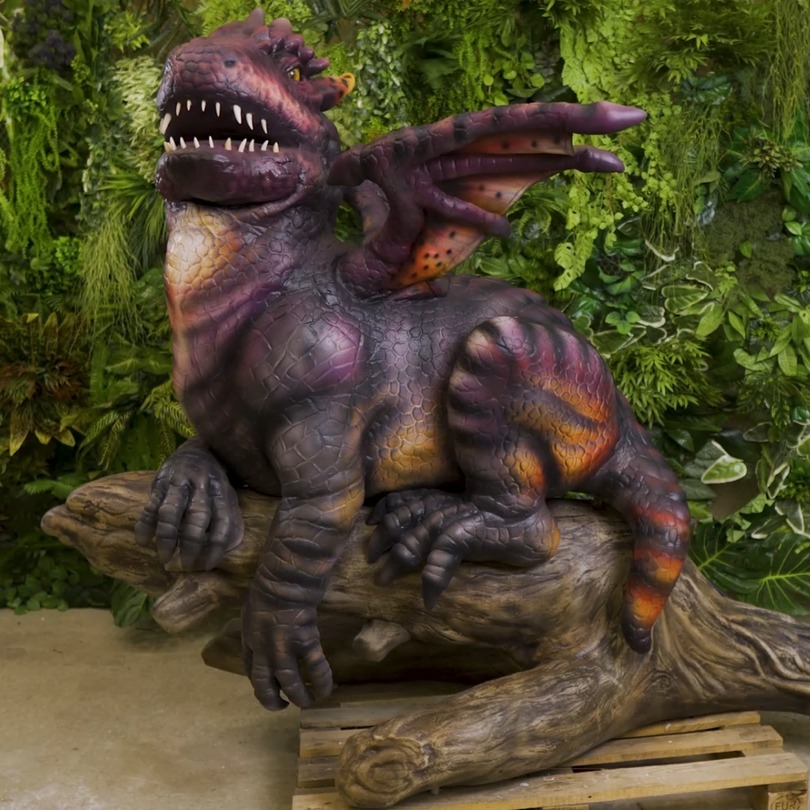 Dragon on a tree - photo of an animatronic figure in stock